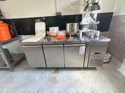 a kitchen with a lot of appliances and a counter