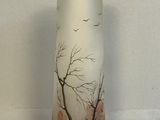a white vase with a painting of a tree on it