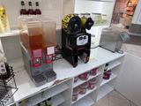 many different types of juices on the counter in this store