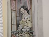 an open book with a picture of a woman sitting on a window sill