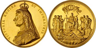 a close up of a gold coin with an image of a woman on it