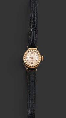 a gold plated wrist watch with a black leather strap