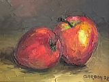 two apples that are sitting on a table