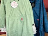 two coats hanging on a rack in a room