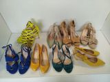 several pairs of women ' s shoes are lined up on a shelf