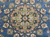 a blue rug with a floral design on it