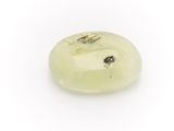 a close up of a green jade stone on a white surface