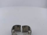 a close up of a silver bracelet on a white surface
