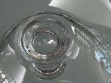 a close up view of a glass object on a white surface