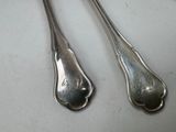 two spoons that are sitting next to each other on a table