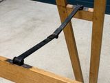 a close up of a wooden table with a black handle