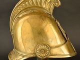 an antique helmet with a red flower on the top of it