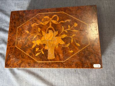 an image of a wooden box with a flower design on it
