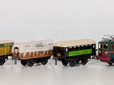 a lot of toy trains that are lined up on the table