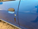 a close up of a car door with a sticker on it