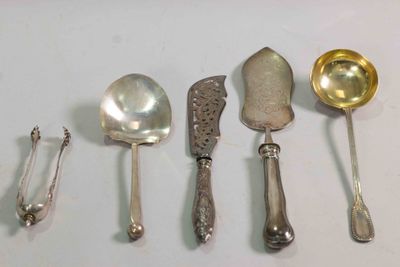five spoons and a ladle on a table