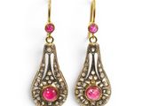 a pair of pink and gold earrings