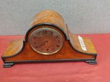 a small clock that is sitting on a red table