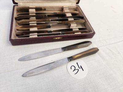 a lot of knives in a case on a table