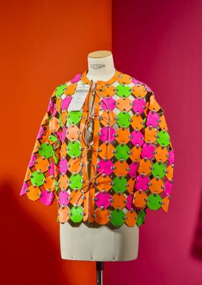 a close up of a mannequin with a colorful jacket on it