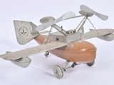 a toy airplane that is sitting on a white surface