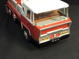 a red and white fire truck on a black surface