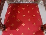 a red chair with a gold pattern on it