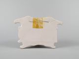an image of a white and yellow ceramic box with a handle