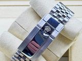 a rolex watch that is in a box on the table