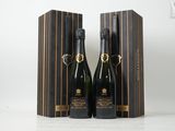 deux bouteilles de champagne dans un coffret en bois posé sur une table