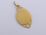 an image of a gold pendant with a heart cut out of it