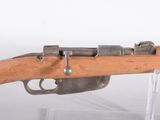un vieux fusil au canon en bois exposé dans une vitrine