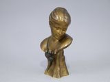 bronze figurine of a boy holding a cat on a white surface