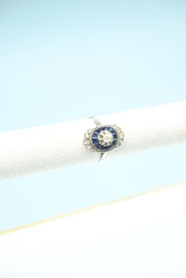 an image of a diamond and sapphire ring on a white napkin