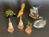 five small figurines sitting on a black surface