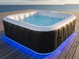 an inflatable hot tub on a wooden deck overlooking the ocean