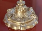 a gold candle that is on a red table