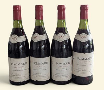 four bottles of wine are lined up on a white surface