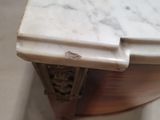 a marble top table with a drawer underneath it