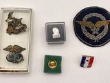 a small box of pins and other items on a table