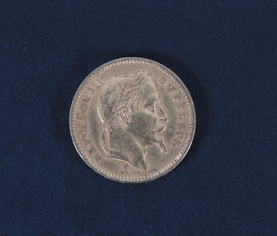 an image of a silver coin on a blue surface