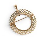 an image of a gold plated brooch with a circular design