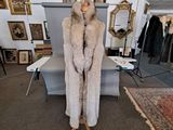 a fur coat on a mannequin stand in a room