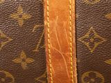 a close up of a brown and tan louis vuitton bag