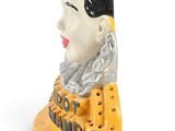 a figurine of a woman with a scarf on her head