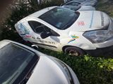many cars parked in a row on the side of the road