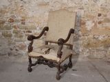 a chair that is sitting in front of a brick wall