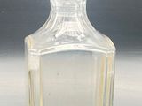 a clear glass bottle sitting on a table