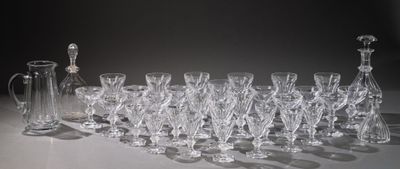 a lot of wine glasses and a pitcher on the table