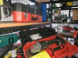 a red tool box sitting on a shelf next to other tools